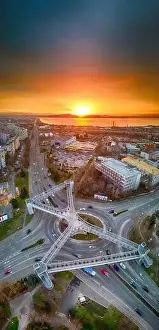 Panorama view of the road with a circular motion and a flower bed at sunset. Aerial photography