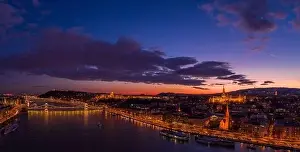 Beautiful Sky Prints: Panoramic aerial drone of lighted Matthias Church on Buda Hill by Danube river during Budapest sunset