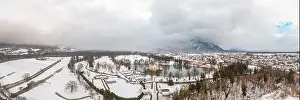 Panoramic aerial drone shot of Anif Schloss moated castle in artificial pond at Salzburg outskirts in heavy snow during