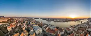 Morning Glow Prints: Panoramic aerial drone shot of Budapest skyline sunrise over Danube river with Hungarian Parliament