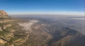 Panoramic aerial drone shot of Cap de Bou at Montserrat near Barcelona with morning fog