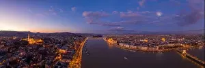 Beautiful Sky Prints: Panoramic aerial drone shot of Danube river with lighted quai with purple sky during Budapest sunset