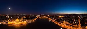 Quai Prints: Panoramic aerial drone shot of front facade of Hungarian Parliament with lights on in Budapest night