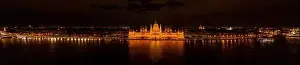 Neo Gothic Prints: Panoramic aerial drone shot of Hungarian Parliament with lights on during Budapest evening