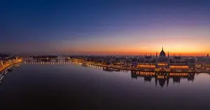 Panoramic aerial drone shot of Hungarian Parliament lights off sunrise in Budapest dawn
