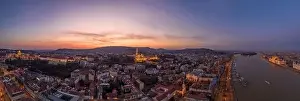Beautiful Sky Prints: Panoramic aerial drone shot of lighted Matthias Church Buda castle on Buda Hill by Danube in Budapest sunset