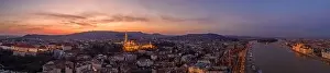 Beautiful Sky Prints: Panoramic aerial drone shot of lighted Matthias Churh Buda castle on Buda Hill by Danube in Budapest sunset