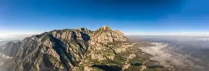 Benedictine Prints: Panoramic aerial drone shot of Montserrat near Barcelona in mountain range in morning