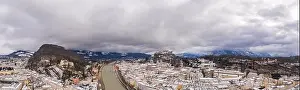 Salzach Prints: Panoramic aerial drone shot view of Salzburg after sunset in winter with snow