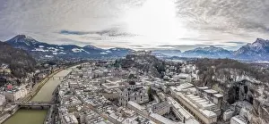 Salzach Prints: Panoramic aerial drone shot view of snowy salzburg city center with view of Cathdrals and fortress in winter