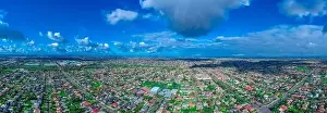 Panoramic aerial Drone view of Melbournes suburbs and CBD looking down at Houses roads and Parks Victoria Australia