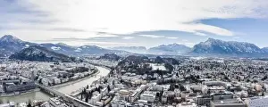 Salzach Prints: Panoramic aerial drone view of Salzburg snowy old town with Hohensalzburg fortress Unesberg mountain in winter morning