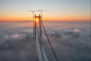 Water Transportation Prints: Panoramic aerial drone view from above of the suspended bridge over danube river