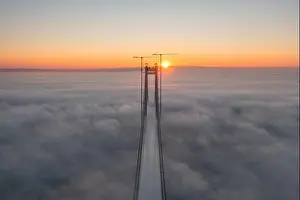 Panoramic aerial drone view from above of the suspended bridge over danube river, under construction, between Braila and Tulcea cities in Romania