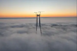 Panoramic aerial drone view from above of the suspended bridge over danube river, under construction, between Braila and Tulcea cities in Romania