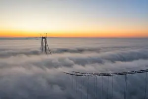 Panoramic aerial drone view from above of the suspended bridge over danube river, under construction, between Braila and Tulcea cities in Romania