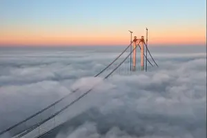 Panoramic aerial drone view from above of the suspended bridge over danube river, under construction, between Braila and Tulcea cities in Romania