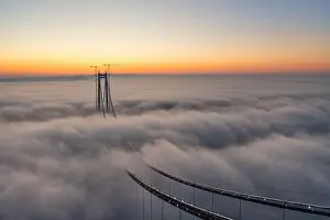 Panoramic aerial drone view from above of the suspended bridge over danube river, under construction, between Braila and Tulcea cities in Romania