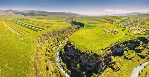 Armenia Prints: Panoramic aerial view of agricultural fields sown with crops and river in deep canyon