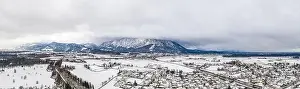 Untersberg Prints: Panoramic aerial view of Austrian mountain half in fog with Anif snowy village in outskirt in the foreground in winter