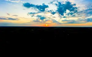 Lamphun Prints: Panoramic aerial view of beautiful green tropical forest with mountains and majestic blue sky and clouds