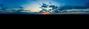 Lamphun Prints: Panoramic aerial view of beautiful green tropical forest with mountains and majestic blue sky and clouds