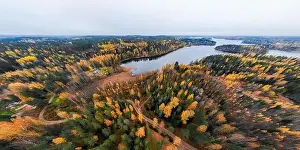Panoramic aerial view of lake and colorful forests on a autumn day in Finland. Drone photography