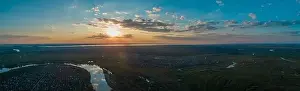 Water Country Prints: Panoramic aerial view of the nature landscape with green meadows and a river at sunset