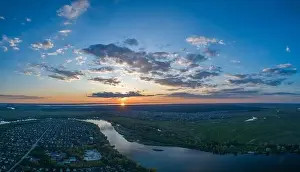 Water Country Prints: Panoramic aerial view of the nature landscape with green meadows and a river at sunset
