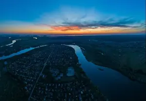 Water Country Prints: Panoramic aerial view of the nature landscape with green meadows and a river at sunset