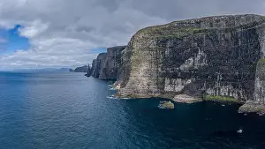 Mavic Prints: Panoramic aerial view from Sandoy island cliffs and rock stacks under the clouds