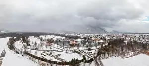 Snow Mountain Prints: Panoramic aerial view of Schloss Anif castle moated in artificial pond near Salzburg outskirts in heavy snow during