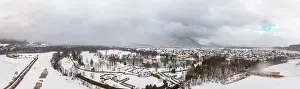 Snow Mountain Prints: Panoramic aerial view of Schloss Anif moated in artificial pond at Salzburg outskirts in heavy snow during winter view