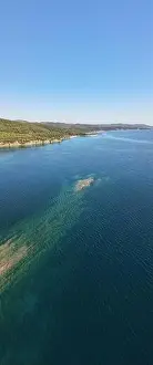 Surfers Prints: Panoramic drone photo of the tropical beach in the bay of Toroni in Halkidiki, Greece