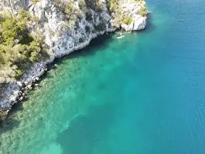Surfers Prints: Panoramic drone photo of the tropical beach and a SUP paddleboard in the bay of Toroni in Halkidiki
