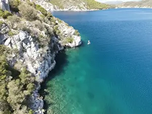 Surfers Prints: Panoramic drone photo of the tropical beach and a SUP paddleboard in the bay of Toroni in Halkidiki