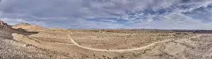 Panoramic drone picture over a gravel road near Fish River Canyon in southern Namibia under a blue sky in summer