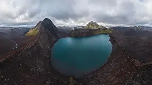 Crater Lake Prints: Panoramic drone shot of a vast highlands area in Iceland featuring a stunning crater lake surrounded by rugged