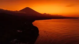 Agung Prints: Panoramic drone view of coastline with volcano and sunset with quiet ocean in Bali
