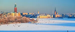 Strolling Prints: Panoramic image of people strolling across frozen Riddarfjarden toward Riddarholmen in Stockholm winter