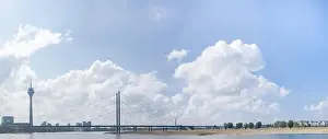 Panoramic photo of the teleradio tower and bridge from the embankment in Düsseldorf