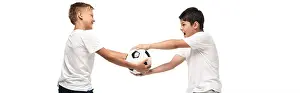 Pajamas Prints: panoramic shot of angry boy taking soccer ball away from brother isolated on white