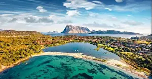 Panoramic spring view from flying drone of Salina Bamba beach with Tavolara mountain on background