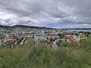 Hilly Prints: Panoramic view of Bergen city with hills in the background under a cloudy sky