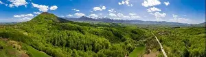 Contrasts Prints: panoramic view from drone of the mountain with green hills and road in spring
