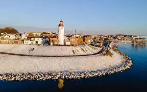 Water Tourism Prints: panoramic view of the Lighthouse of Urk during winter with snow landscape in the Netherlands