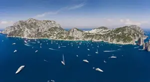 Panoramic view of south Capri Island coastline and faraglioni limestone crags in Tyrrhenian sea