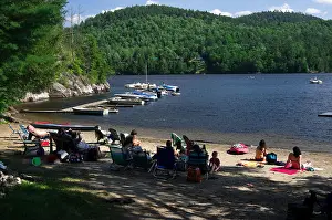 Water Sports Prints: Paradox Lake, residents sit in beach chairs in the shade at water's edge