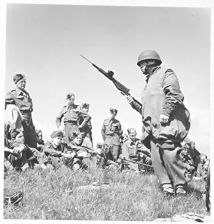 Maneuver Prints: A paratroop demonstrates a Sten gun with bayonet to Wiltshire Cadets during a British Army demonstration