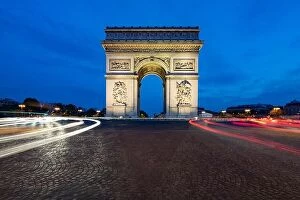 Images Dated 7th May 2016: Paris street at night with the Arc de Triomphe in Paris, France
